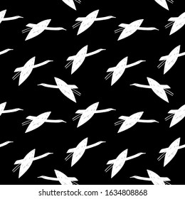 Seamless pattern white cranes swans, herons birds fly, simple lines scandinavian style black background. trend of the season. Can be used for Gift wrap fabrics, wallpapers. Vector 
