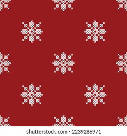Seamless pattern with white cross-stitched snowflakes on a red background