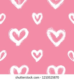 Seamless pattern with white hand-drawn uneven hearts isolated on pink background. Ink doodle style abstract grunge texture.