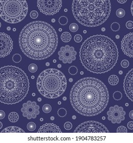 Seamless pattern with white lace mandalas on dark blue background. Vector design.