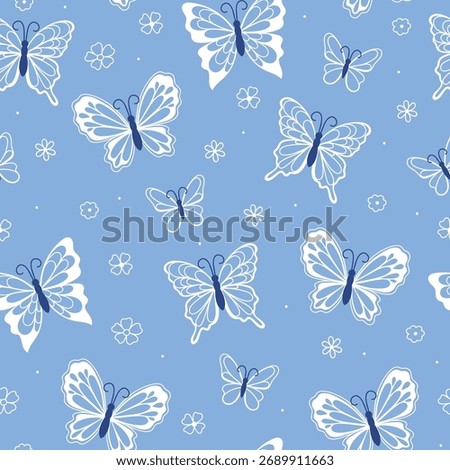 Seamless pattern with white lacy butterflies on a blue background. Vector graphics.