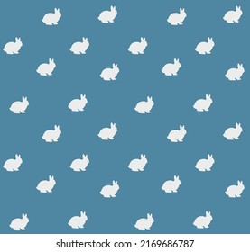 Seamless pattern with white little rabbits on the blue background. Cute animals wallpaper in vector style.