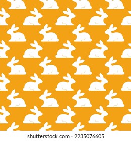 Silueta de conejo blanco sin foco sobre fondo naranja.