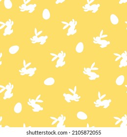 Seamless pattern with white silhouette Easter rabbits on yellow background. Design for card, postcard, wallpaper, fabric, textile. Vector stock illustration. Cartoon style.