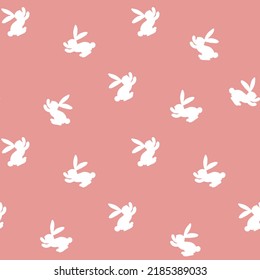 Seamless pattern with white silhouette Easter rabbits on pink background. Design for card, postcard, wallpaper, fabric, textile. Vector stock illustration. Cartoon style.