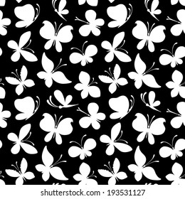 Seamless pattern of white silhouettes of butterflies on black background. Duotone vector illustration for your design.
