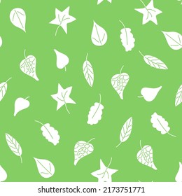 Seamless pattern of white silhouettes of leaves on a green background. Summer Pattern. High quality photo