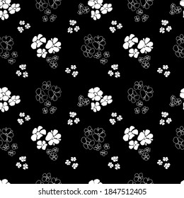 Seamless pattern of white silhouettes and outlines of abstract flowers on a black background. Trendy abstract art template for printing on fabric, wrapping paper, cover, cards, background