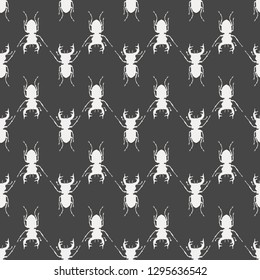 Seamless pattern with white silhouettes of stag beetles on black backdrop. Beetles on the background. Wallpaper with bugs. Insect vector illustration