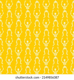 Seamless pattern with white skeletons on a yellow background . Halloween pattern