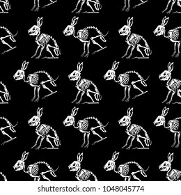 Seamless pattern. White skeletons of rabbits on a black background. Anatomy of a hare. Great for printing on T-shirts, for tattoos and more. Ideal for decoration of Halloween and the Day of the Dead.