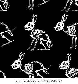 Seamless pattern. White skeletons of rabbits on a black background. Skull and Bones. Great for printing on T-shirts, for tattoos and more. Ideal for decoration of Halloween and the Day of the Dead.