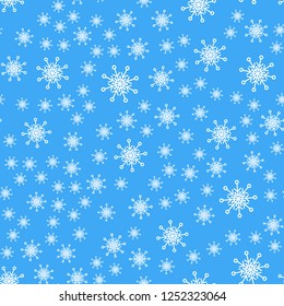 Seamless pattern. White snowflakes on a blue backgrounds. For packaging paper