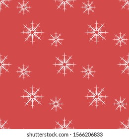Seamless pattern with white snowflakes on red background. Vector image. 
