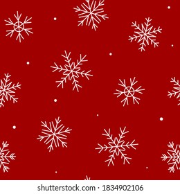 Seamless pattern with white snowflakes on a red - holiday background for Christmas and New Year winter design