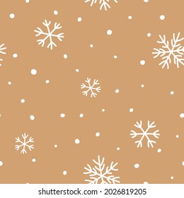 Seamless pattern with white snowflakes on craft paper. Perfect for New Year's wrapping paper.
