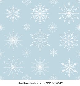 Seamless pattern of white snowflakes on a pastel blue background
