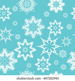 Seamless pattern of white snowflakes on a turquoise background