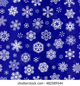 Seamless pattern of white snowflakes on a blue background.