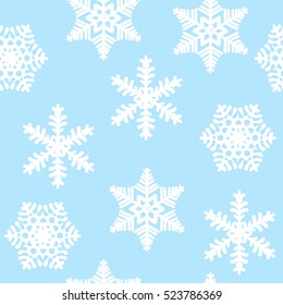 Seamless pattern of white snowflakes on a blue background