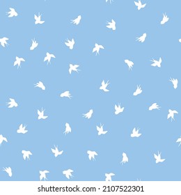 Seamless pattern with white swallow silhouette on blue background. Cute bird in flight. Vector illustration.  Doodle style. Design for invitation, poster, card, fabric, textile.