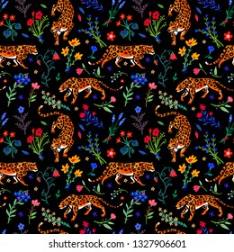 Seamless pattern. Wild cats in the blooming garden. Leopards among flowers and herbs. Summer meadow. Night bloom. Trend hand drawn vector illustration. Fashion leopard print.