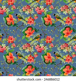 Seamless pattern with wild exotic birds on the branch with flowers on blue background vector illustration