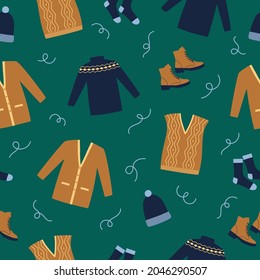 Seamless pattern winter clothes. Blue sweater, boots, socks, waistcoat and cardigan on blue background. Doodle style. Vector illustration