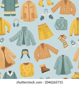 The seamless pattern with winter clothes. Coats, The vector set of winter clothes. Coats, hats, gloves, shoes and socks.