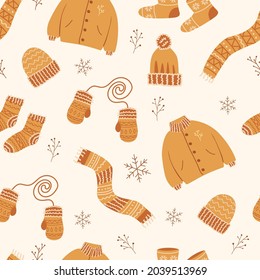 Seamless pattern with winter clothing. Christmas pattern. New Year's pattern with children's things for textiles and design of packaging, gifts, decoration of holiday pages. Knitted clothes. Vector.