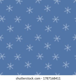 Seamless pattern with winter snowflakes. Snow texture. Vector illustration in doodle style on blue background