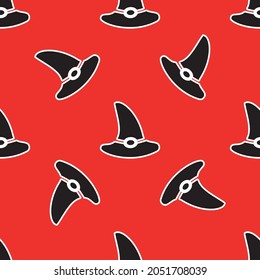 Seamless pattern with a witches hat on a red background. Vector illustration for Halloween design