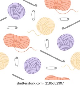 Seamless pattern with yarn balls and crochet hooks. 