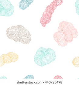 Seamless pattern - yarn balls and skeins of yarn in pastel colors hand drawn vector illustration. Sketch doodle style knitting elements on white background. For textile, paper, web design.