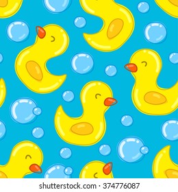 Seamless pattern with yellow ducks on blue background