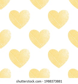 Seamless pattern of yellow hearts with tree leaf veins. Vector image.