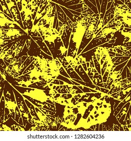 Seamless pattern of yellow leaf prints. Vector illustration on brown background.