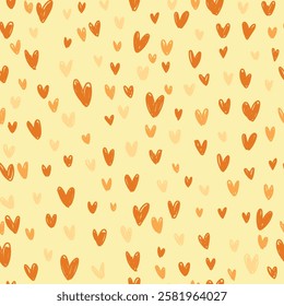 Seamless pattern with yellow and orange hearts on light yellow background. Hand drawn hearts pattern.