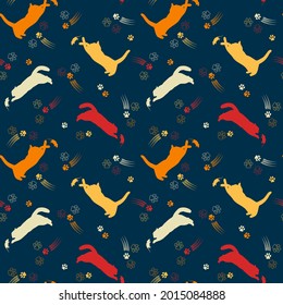 Seamless pattern with yellow, orange, red silhouettes of cats, mouse, contour cat footprint, scratches on blue background. Active cats jump, catch. Vector image in contrasting colors.