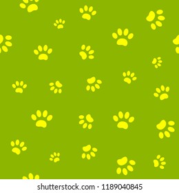 Seamless pattern of yellow paw prints on green background.