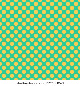 Seamless pattern with yellow polka dots on a green background. Traditional tile design in vintage pop art style. Vector illustration