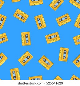 Seamless pattern with yellow retro audio tape on blue background.