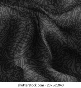 Seamless patterned black fabric with a floral pattern in the form of vines