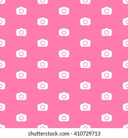 Seamless photography pattern with white cameras and pink background. Photo background template with dslr camera icons.