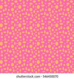 Seamless pink pattern with orange polka dots in different sizes as a background - Eps10 vector graphics and illustration