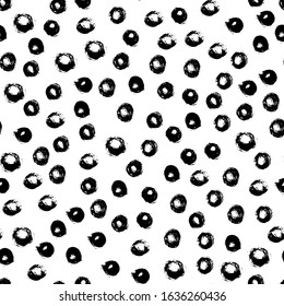 Seamless polka dot pattern hand drawn with a brush. Vector Monochrome Grunge texture of circles. Scandinavian background in a simple style for printing on textiles, paper, Wallpaper, print on t-shirts