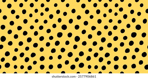 Seamless polka dot pattern. Vector illustration with small black freeform dots on a cheerful yellow backdrop. Creative texture of chaotic round shapes. Cute dotted wrapping paper sample