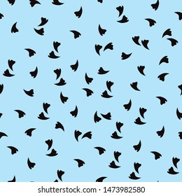 Seamless print of small flying petals on a blue background.
