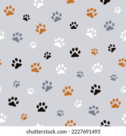 Seamless prints of footprints. 
Grey background. Cute black, white, gray animal footprints. Printing on textiles and wallpaper. Cat paws. Vector texture. 