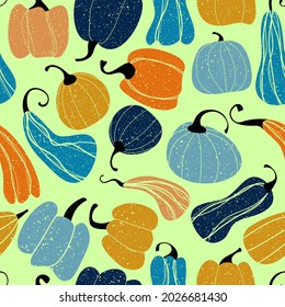 Seamless pumpkin background. Blue and orange pumpkins on a light green background with a grunge effect. Vector illustration isolated on a white background for design and web.